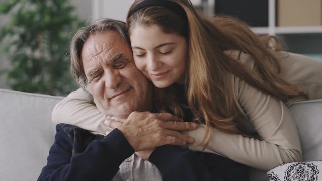 Girl hugging her father with love