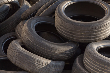 Pile of old used tires, closeup background.