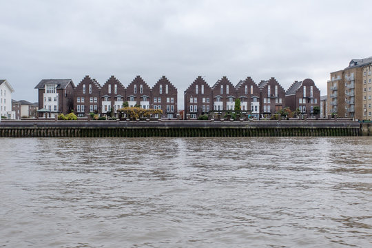 Old English houses along the Thames river