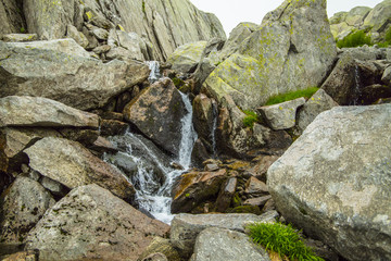 Mountain river on a background of gray mountain stones