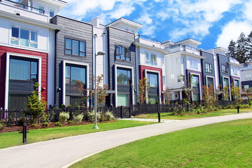 Beautiful new contempory suburban attached townhomes with colorful summer gardens in a Canadian...