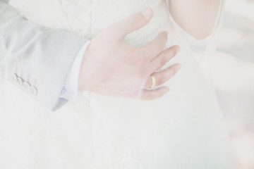 close portrait of the hand of the groom who hugs the bride. Wedding day