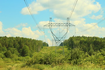 Metal poles of power lines. High-voltage direct current line. Power transmission towers. Close-up...