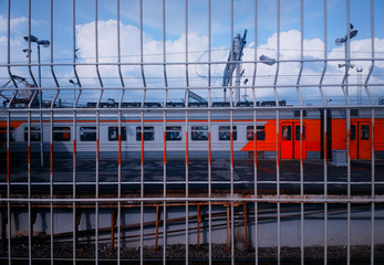 Fototapeta na wymiar Russian railway train through jail fence background
