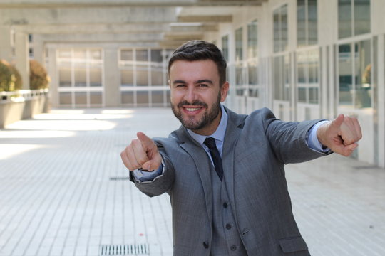 Confident businessman pointing at camera 