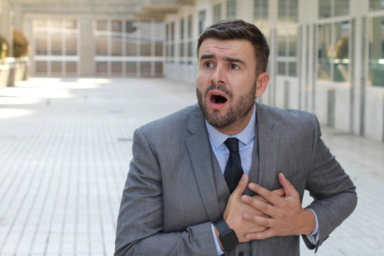 Businessman experimenting chest pain at work 