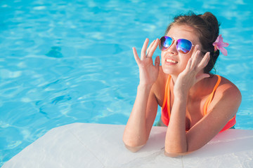 young beautiful woman in bikini relaxing in spa pool