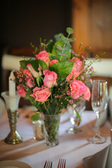 Obraz na płótnie Canvas Wedding Reception Table Decorated with Silver and a Pink, White, and Green Centerpiece of Roses