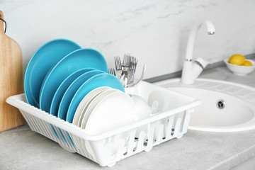Fototapeta na wymiar Different clean tableware near sink in kitchen