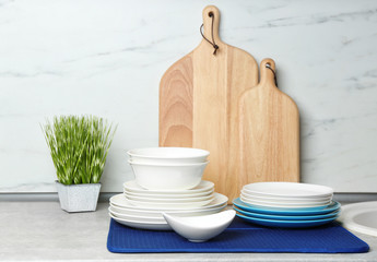 Different clean plates on counter in kitchen
