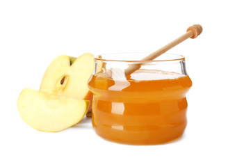 Glass jar with sweet honey and apples on white background