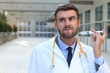 Doctor injecting himself in the hospital