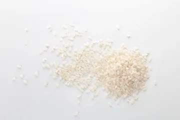 Fotobehang Raw rice on white background. Healthy grains and cereals © New Africa
