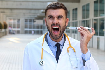 Crazy doctor injecting himself a drug 