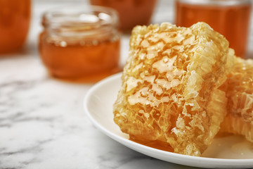 Plate with honeycombs on table, closeup