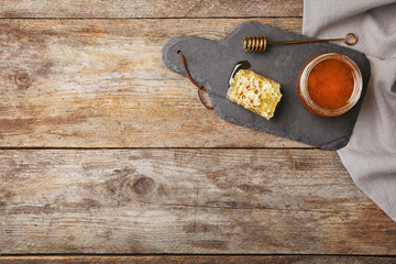 Flat lay composition with fresh honey on wooden background
