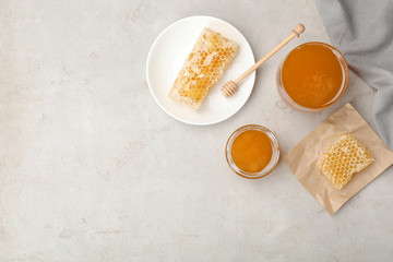 Flat lay composition with fresh honey on gray background