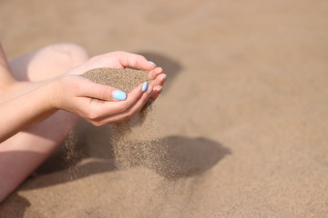 hand with sand. girls hand with kight sand. summer concept. beach and sea