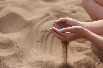 hand with sand. girls hand with kight sand. summer concept. beach and sea