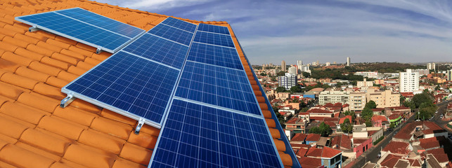 Photovoltaic power plant on the roof of a residential building on sunny day - Solar Energy concept...
