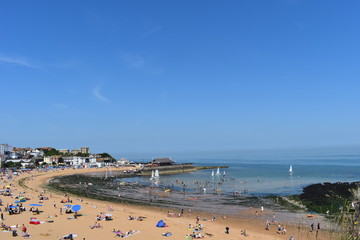 Fototapeta na wymiar People on the beach in Broadstairs, Kent as the hot weather continues across the UK