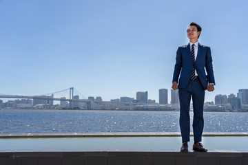 portrait of asian businessman in blue sky
