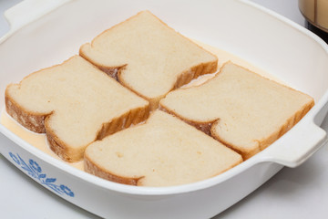 French toast preparation: Soaking bread in the mix for french toast preparation
