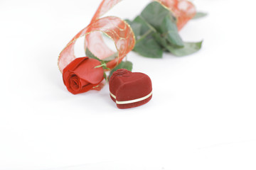 red rose and box with ring on white background.photo with copy space