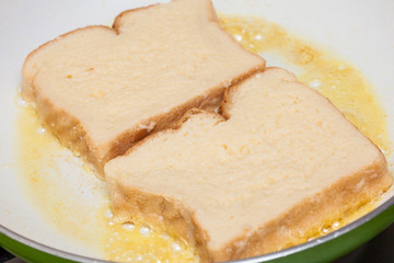 French toast preparation: Cooking french toasts on a pan
