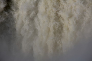  close-up of large waterfalls with rainbow