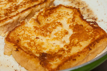French toast preparation: Cooking french toasts on a pan
