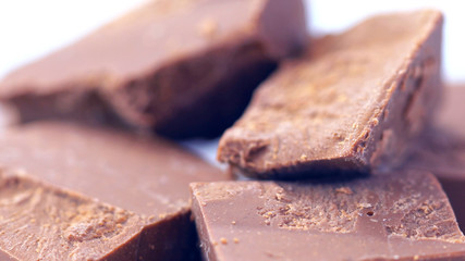Chunks of chopped premium Belgian Gianduja chocolate macro closeup.