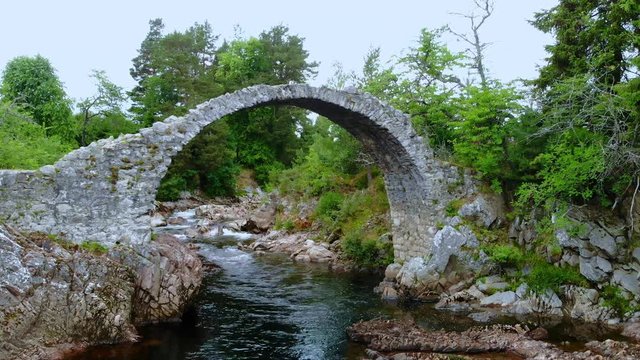 Famous stone bridge over a creek in the village of Carrbridge Scotland
