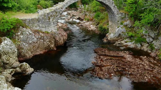 Famous stone bridge over a creek in the village of Carrbridge Scotland