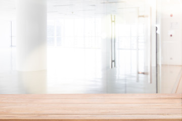 Blur inside Modern office with open space. Wooden table top for montage product display.