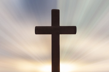 Silhouettes of crucifix and colourful sky background