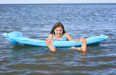 girl of thirteen with an inflatable mattress