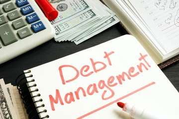 Debt management. Notepad, calculator and money.