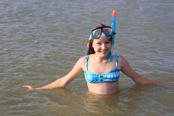 girl of thirteen in a mask for diving into the sea