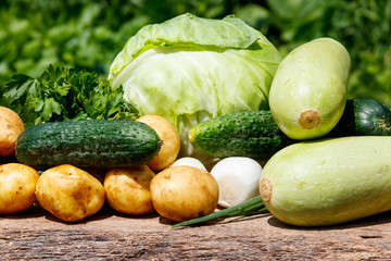 Fresh vegetables on rustic wooden table outdoor