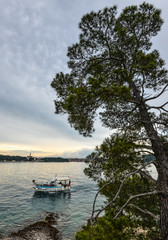 Naklejka na ściany i meble Rovinj, Croatia - May 22, 2018: Adriatic sea and fishing boat near Rovinj town, Croatia