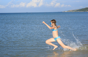 girl of thirteen in a mask for diving into the sea
