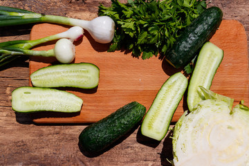 Ingredients for spring vegetable salad on rustic wooden table