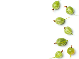 Heap of ripe green gooseberry berries on white background. Creative layout made of organic gooseberries. Isolated on white with clipping path. Top view or flat lay. Copy space for text. Food concept.