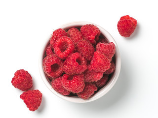 View from above of ripe raspberry in small bowl on white background. Organic raspberries isolated on white with clipping path. Top view or flat lay. Copy space for text
