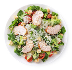 Caesar salad with chicken fillet and parmesan cheese isolated on white background.