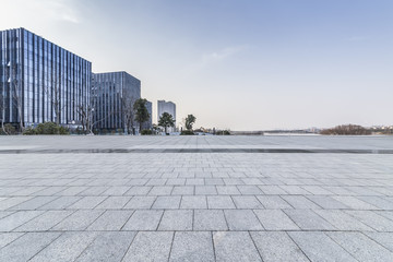 Panoramic skyline and modern business office buildings with empty road,empty concrete square floor