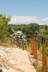 Rocky hiking trail secured with steel cables to the viewpoint above Labeaume at the river Ardeche in France