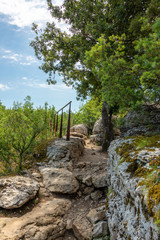 Rocky hiking trail secured with steel cables to the viewpoint above Labeaume at the river Ardeche in France