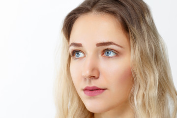 Naklejka premium Pretty young girl with make-up poses in studio, close up portrait